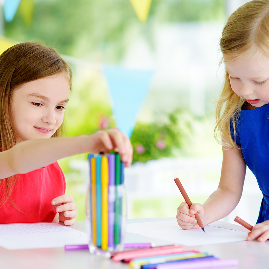 Image of kids drawing with markers