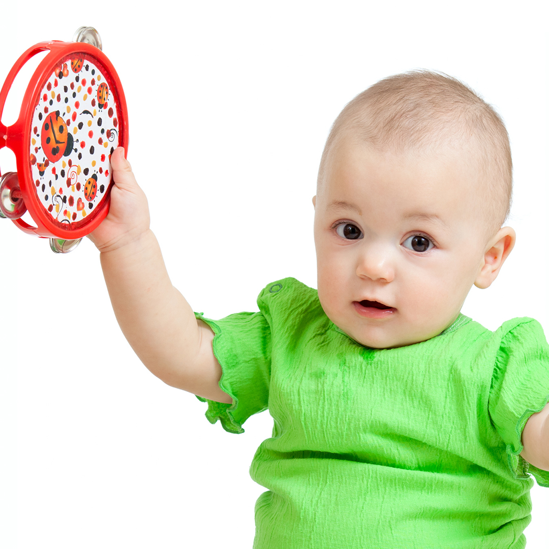 Image of a baby playing with a musical instrument