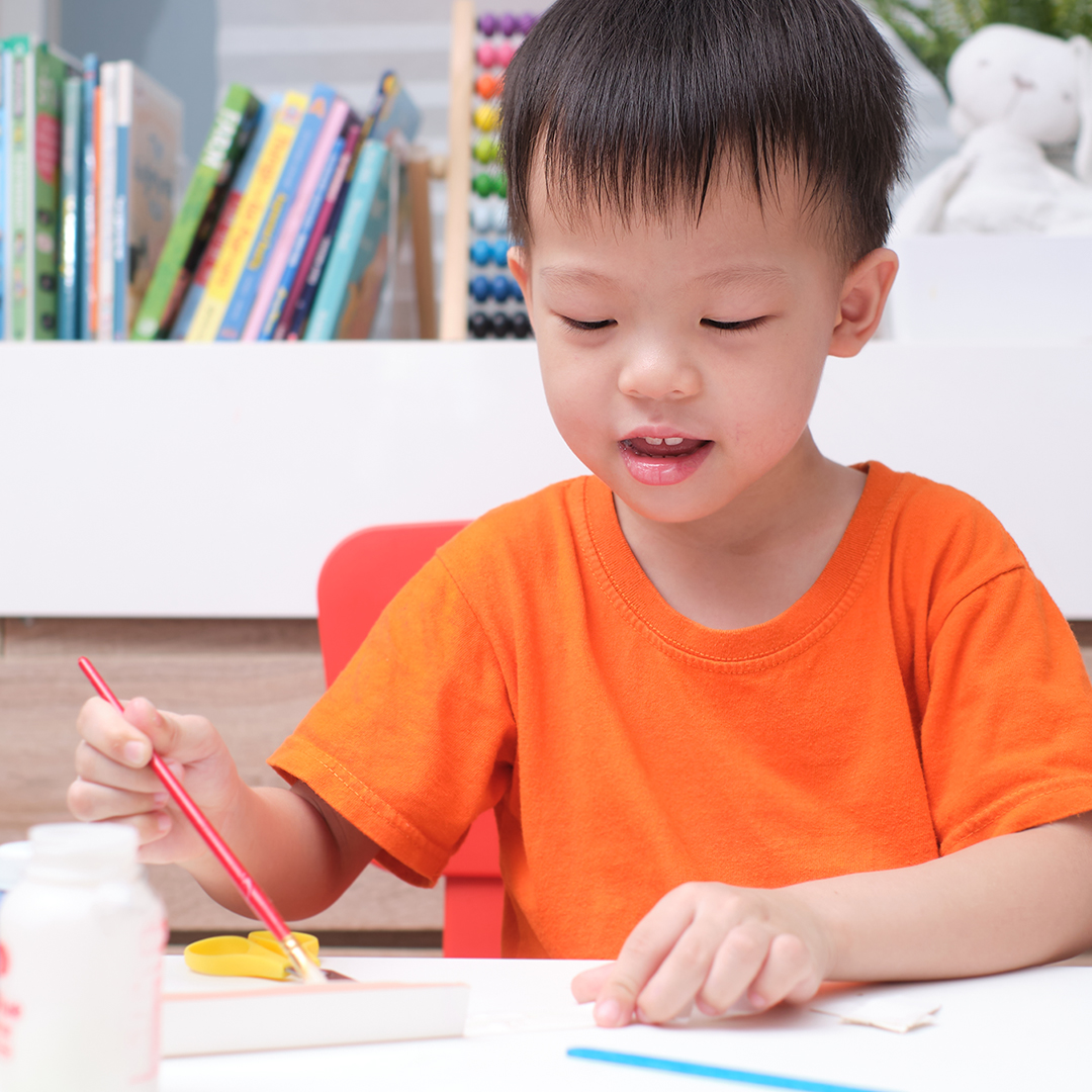 Image of a young boy painting