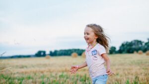 happy child running through field