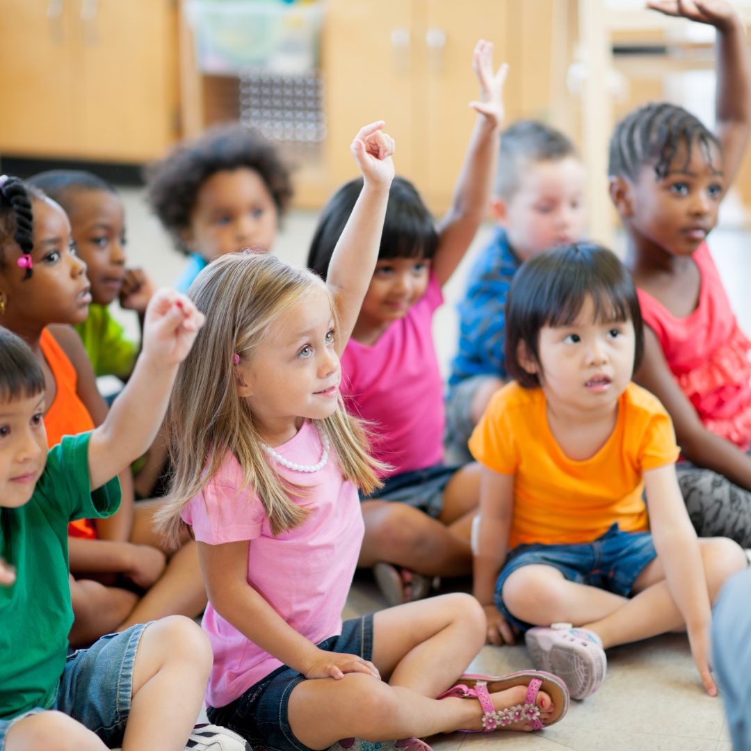 preschoolers raising their hands