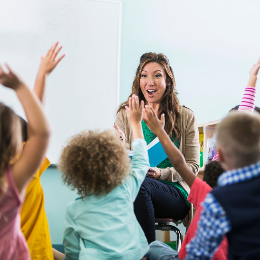 preschoolers raising their hands