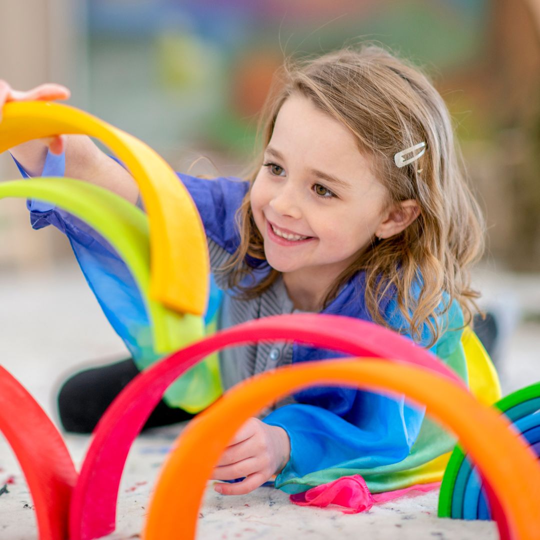 girl playing with toys in preschool