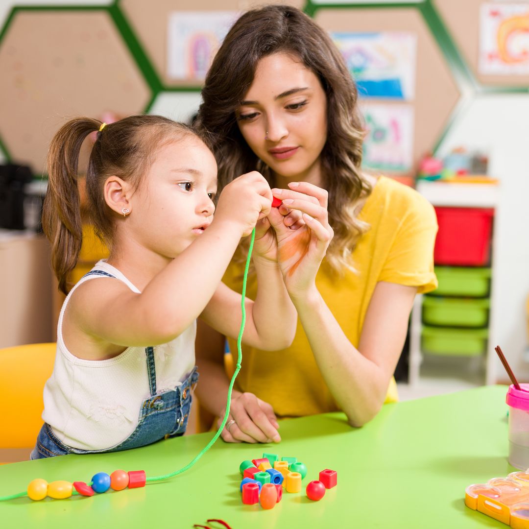 teacher working with preschooler