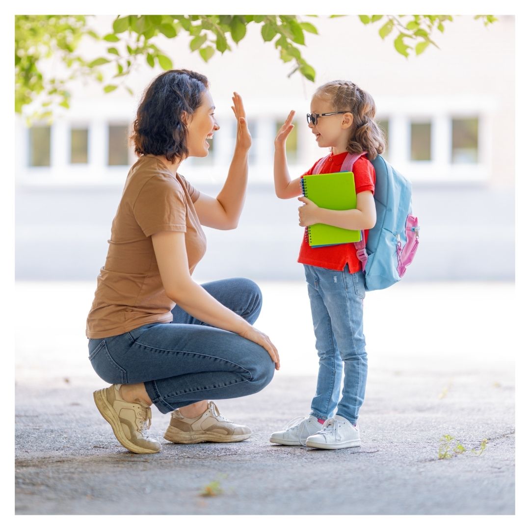 A parent high-fiving their child