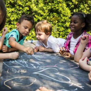 Preschool students learning outside.