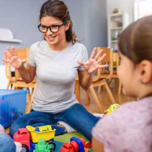 Preschool teacher and students.