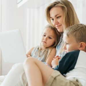 sad kids with mom looking at computer for something to do today